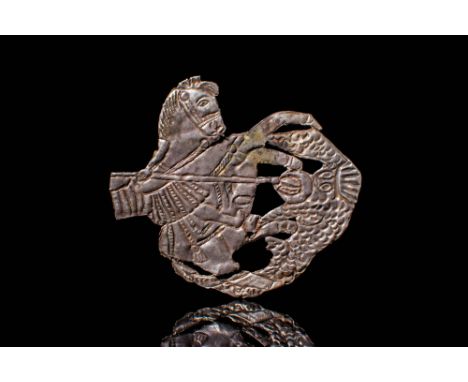 Ca. AD 500 - 700. A silver votive plaque portraying Saint George slaying the dragon with a spear. Saint George is depicted on