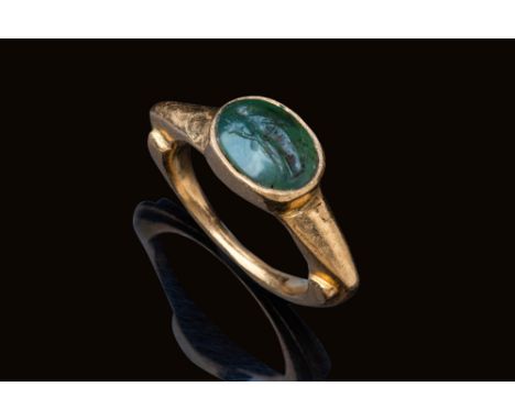 Ca. AD 1 - 200.A slightly convex, oval-shaped green jasper intaglio engraved with a standing female figure identified as Fort