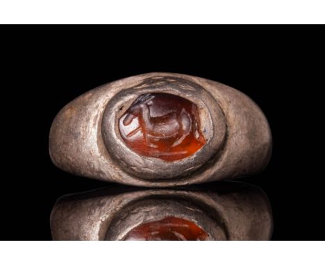 Ca. AD 1 - 300.A carnelian intaglio, oval-shaped, engraved with a depiction of a donkey seen in left profile. The features of