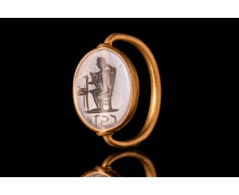 Ca. AD 200.An oval-shaped intaglio with a flat underside and a slightly convex base engraved with a depiction of a god seated