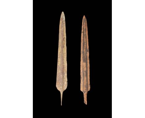 Ca. 2000 - 1600 BC. A pair of European cast bronze daggers. The daggers have sharp edges and a shallow midrib. Attributed to 