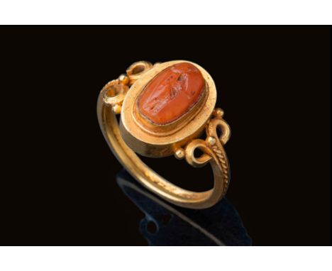 Ca. AD 300 - 400.An oval-shaped carnelian intaglio engraved with a standing goddess. The figure is depicted slightly turned, 