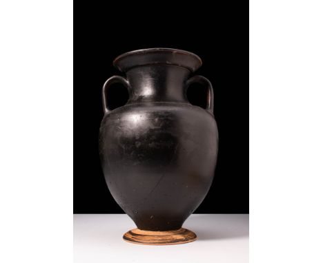 Ca. 400 - 350 BC. A nice pottery amphora with a black glaze. Sitting upon a discoid foot, the vessel has a bulbous body with 