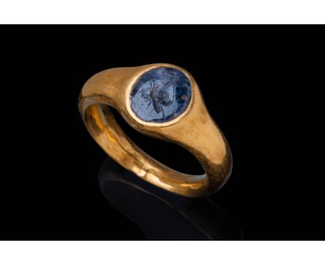 Ca. AD 100 - 200.A rare oval-shaped sapphire intaglio engraved with the image of a butterfly in flight, shown in left profile