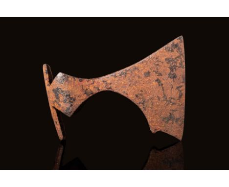 Ca. AD 800 - 1100A massive Viking forged-iron axe head of a hefty form with a circular socket shaft, a narrow neck, and a sli