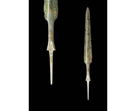 Ca. 1200 - 800 BC.A cast bronze short dagger with a sturdy blade bearing sharpened edges and a raised midrib on both sides. T