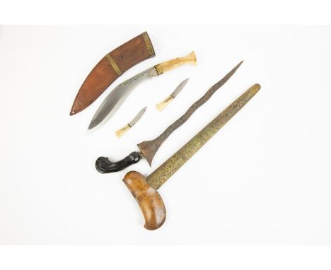 A Malay kris, wavy pamir blade 13", with black wood hilt, in its sheath, the lower part sheathed in embossed brass; also a sm
