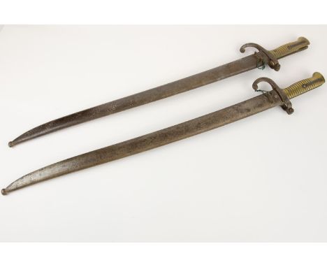 2 Chassepot bayonets, both in scabbards, one marked "WR Kirschbaum", one marked "St Etienne 187...".GC (one has pitting to cr