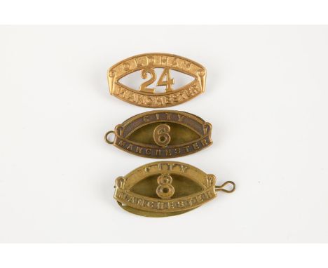 Three "Kitchener's Army" brass shoulder titles: 6th and 8th Manchester City Battalions, and 24th Manchester (Oldham) Battalio