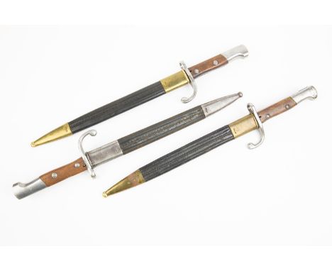 3 Brazilian Mauser sword bayonets, Model 1908, 2 with brass mounted leather scabbards, 1 with steel mounted leather scabbard.