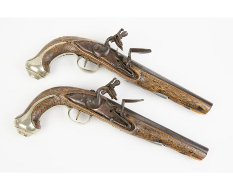 A pair of 20 bore flintlock holster pistols, 12½" overall, barrels 7¼" with faint hints of silver koftgari decoration overall
