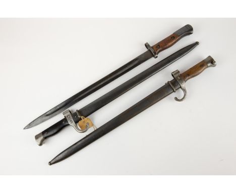 An M1892 French Mannlicher Berthier bayonet, with wooden grips; another with composition grips; one other bayonet (no scabbar