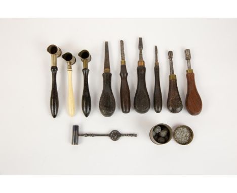 Nine gun tools/accessories: 2 powder measures, a shot measure, 2 nipple keys, and 4 turnscrews; also a reproduction wheel loc