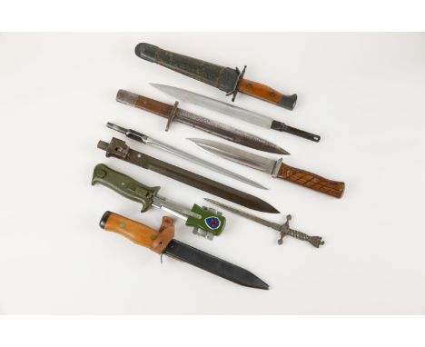 A Continental trench knife, blade 6½", wood grips, in its scabbard; another dated 1956; 2 more made from cut down bayonets; a