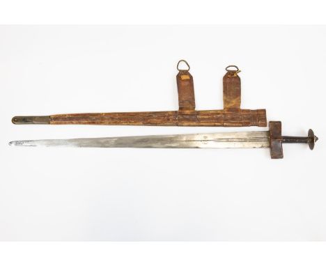 A Tuareg sword, tapered blade 31½" with three narrow fullers and crescent moon marks, with leather covered cruciform hilt and