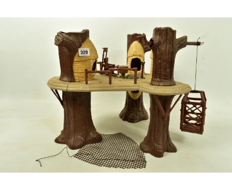 A VINTAGE LFL STAR WARS EWOK VILLAGE PLAYSET 1983, a suspended platform by three trees, with movable elevator, three handrail
