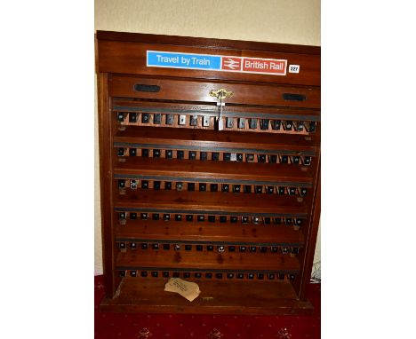 A WOODEN BRITISH RAILWAYS TICKET CABINET,  lockable cabinet with roller shutter front which opens to reveal six flights of si