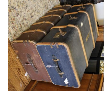 A vintage traveling trunk or suitcase with wood and metal mounts