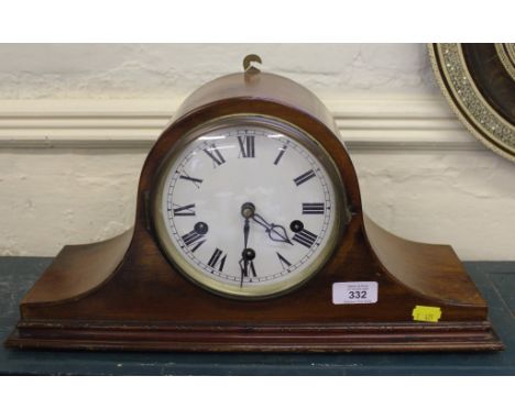 An Edwardian mahogany dome-shaped mantle clock with Roman numerals raised on a stepped base