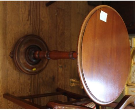 A Victorian mahogany circular occasional table with shaped top, ring turned central column on a platform base and bun feet, 7