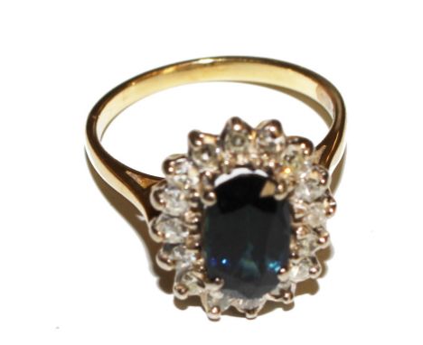 A lady's diamond and sapphire cluster ring