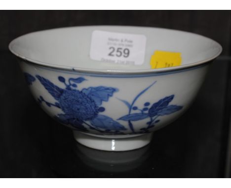 A Chinese Kangxi tea bowl with blue painted peony and ruyi clouds with six character mark to base and of the period, 6cm x 13