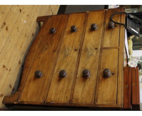 A Regency mahogany chest of two short and three long graduated drawers with circular turned handles, carved apron, raised on 
