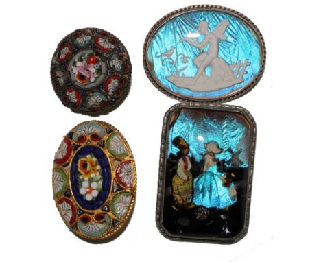 Two silver butterfly wing brooches, one depicting a Dutch boy and girl, the other a fairy playing a flute, together with two 