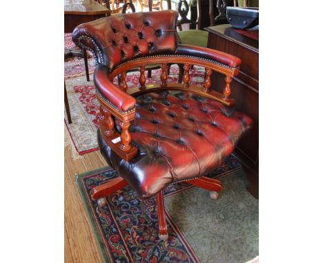 A Norwegian Ring Mekanikk captain's swivel office chair with red button-back leather upholstery, turned spindle supports, ser