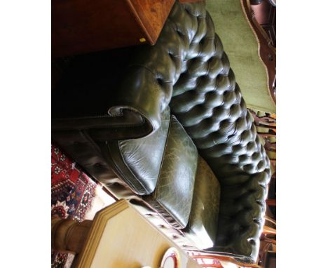 A vintage Chesterfield green-leather upholstered three-seat sofa on bun feet, 190cm wide