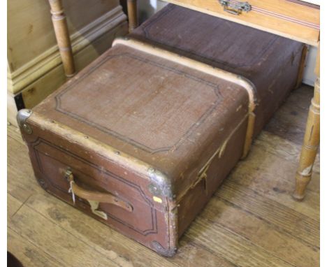 A vintage oblong travel trunk with wood and metal mounts