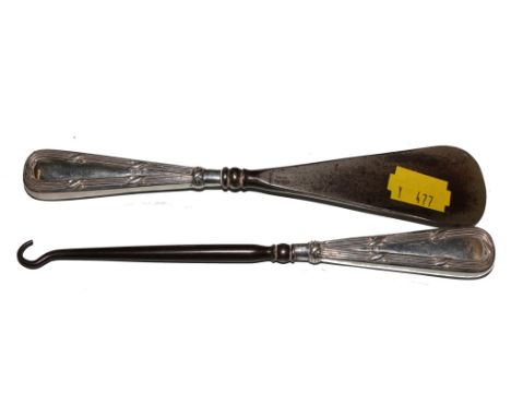 A shoe horn and matching button hook, both with silver handles