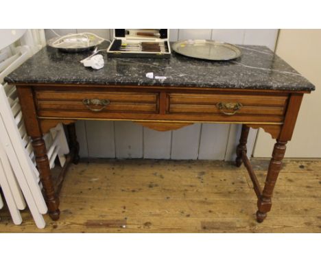 A late Victorian mahogany framed marble topped wash stand with shaped top, two frieze drawers with brass drop handles and car