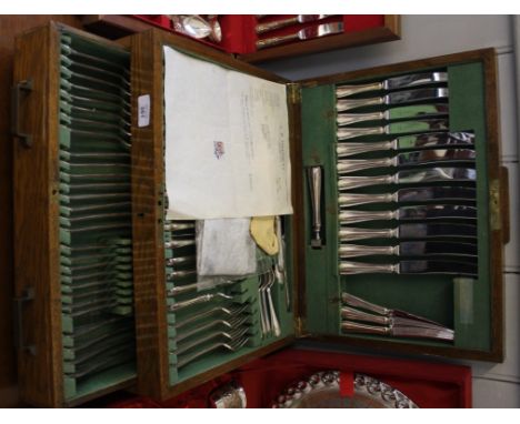 An early 20th century eighty-five piece, oak canteen of silver plated cutlery by Akin Brothers Limited, Sheffield 