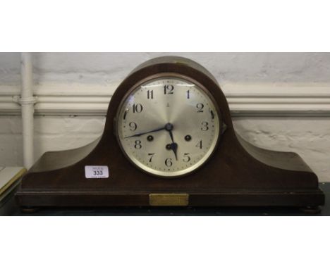 An early 20th century mahogany framed dome-topped mantle clock with Arabic numerals on a stepped base, presented to Mr R.W. S