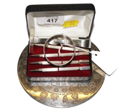 A cased set of silver bridge pencils together with a child's silver pusher and napkin ring, etc