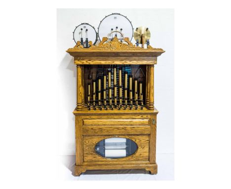 Quarter operated band organ/ orchestrion. It has 2 drums, triangle, xylophone, cymbal, castanets, 43 pipes. In playing condit