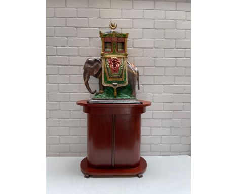 A one of a kind coin-operated elephant with howdah gumball vending machine made in the Netherlands. The ornate arabic design 