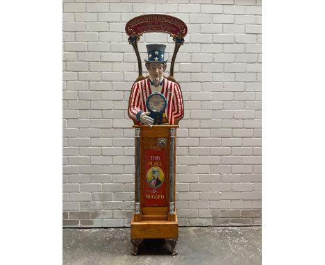 25¢ Shake with Uncle Sam grip tester arcade machine with a tin sign attached to the front of the wood panel - "This place is 