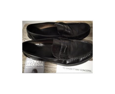A pair of black loafers (Size 9.5 US) worn on stage in 1997 in Germany and signed by Michael Jackson backstage. Height: 30 cm