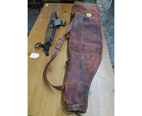 A leather gun case slip and a Sideboatham gamekeepers gin trap, Catalogue note:- the gin tray is sold as an ornamental item o