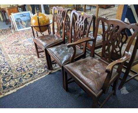 A set of six early 20th century Chippendale style dining chairs with overstuffed upholstered seats raised on sabre forelegsLo