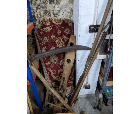 A group of vintage wooden handled garden and farm tools to include a scythe, and a horse's neck yoke Location:GIf there is no