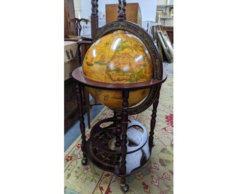 A vintage globe drinks cabinet, having a hinged top opening to reveal a fitted interior, 96cm h x 51cm wLocation: 