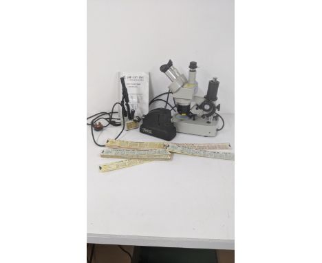 A Meiji EMT 54085 Laboratory microscope together with a minicine magic lantern and film and one otherLocation:If there is no 