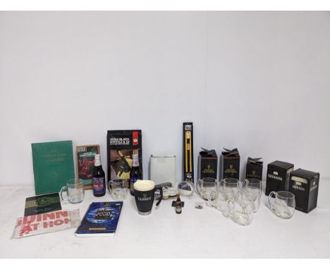 A collection of Guinness memorabilia to include half pint mugs, Silver Jubilee ale model, a boxed Irish black whistle and oth