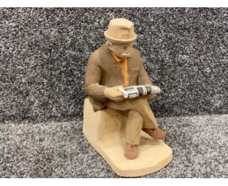 A ceramic old man reading a newspaper made by Deborah Warren 20cm high