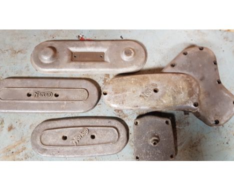 Three Norton engine name covers, a magnesium example and a Triumph engine name cover (5).