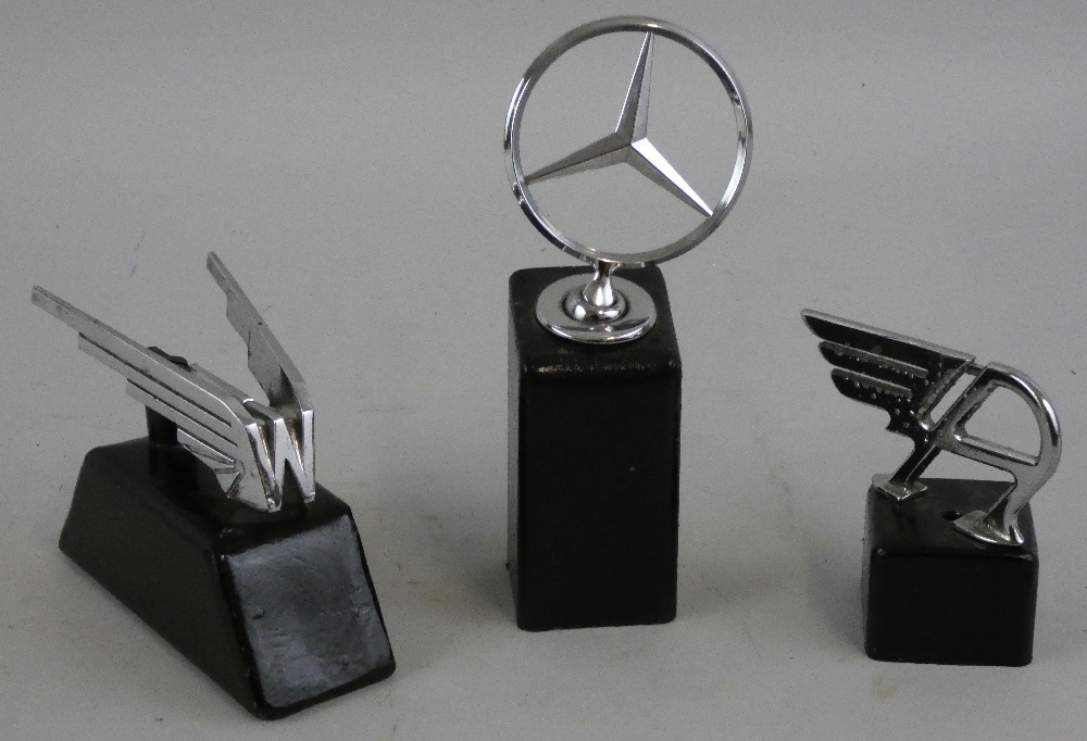 Three chrome car mascots, Wolseley, Austin and Mercedes Benz