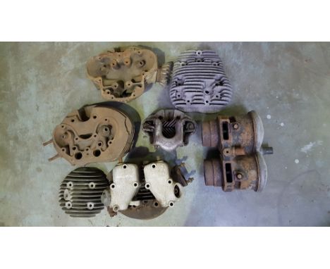 Four cylinder heads and other engine parts.